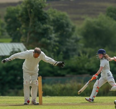 lifestyle image of old versus old playing village cricket at blakesley village cricket field on a hot summer day