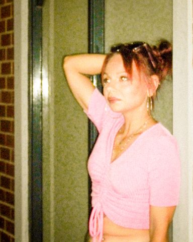 2000s era gritty ccd camera flash look Marie posing in Y2K-inspired fashion during a night flash photography shoot