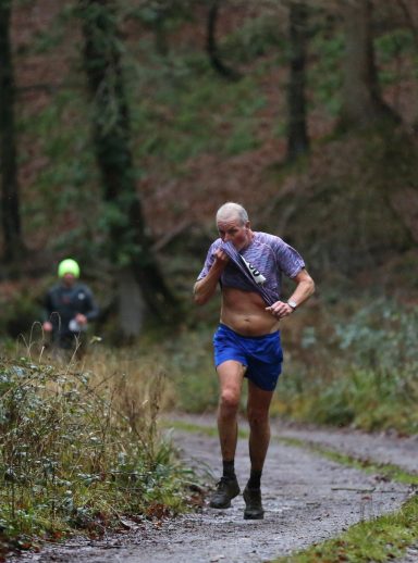 man blowing his nose whilst running a marathon